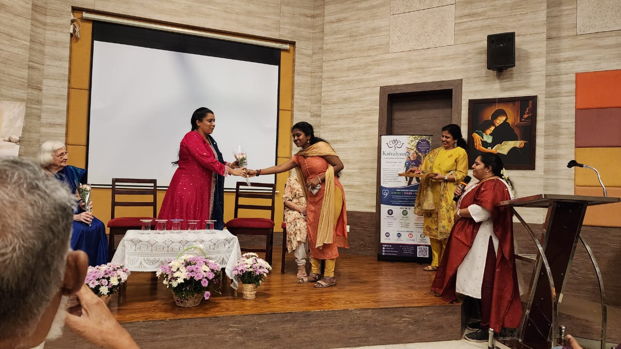 Guest being welcomed on stage with flowers
